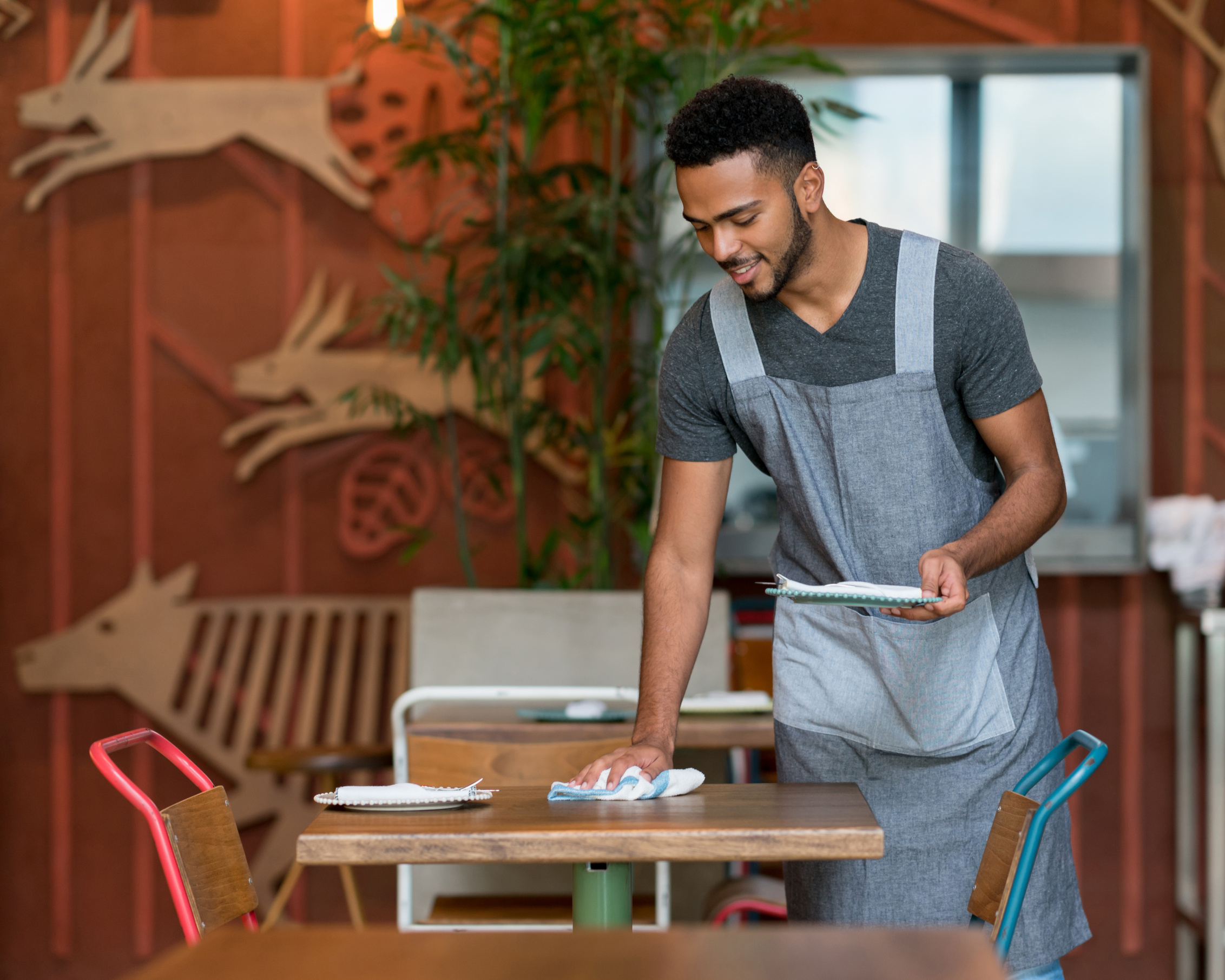 Waiter cleaning the tables at a restaurant